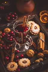 Image showing Mulled wine with cranberry and spices, Christmas cookies and candles