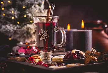 Image showing Mulled wine with cranberry and spices, Christmas cookies and candles