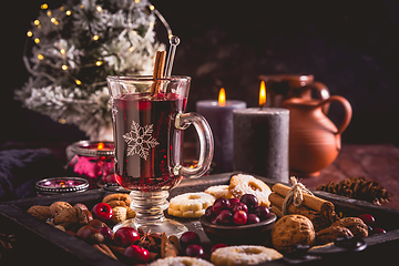 Image showing Mulled wine with cranberry and spices, Christmas cookies and candles