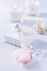 Image showing Christmas ornaments and small present in white