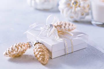 Image showing Christmas ornaments and small present in white