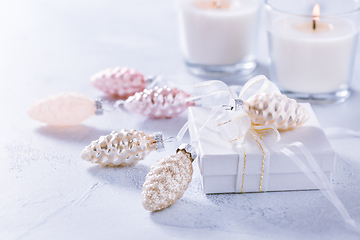 Image showing Christmas ornaments and small present in white