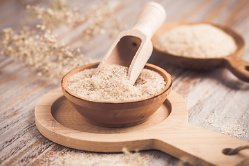 Image showing Isabgol - heap of psyllium husk in wooden bowl on wooden table table