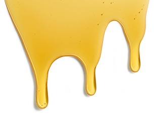 Image showing flowing honey on white background