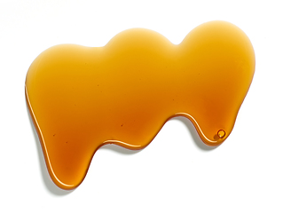 Image showing flowing sugar syrup on white background