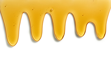 Image showing flowing honey on white background