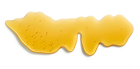 Image showing flowing honey on white background