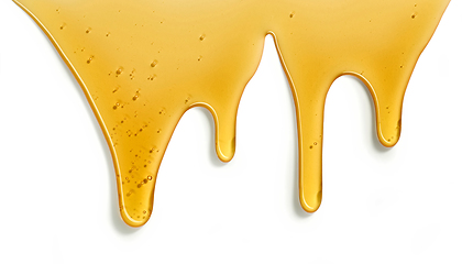 Image showing flowing honey on white background