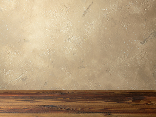 Image showing beige color wall and wooden shelf