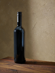 Image showing whine bottle on wooden table