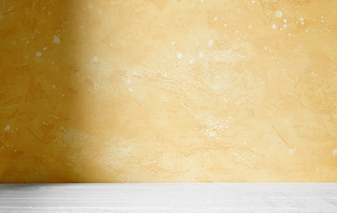 Image showing yellow wall and wooden table