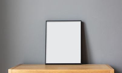 Image showing empty frame on wooden shelf