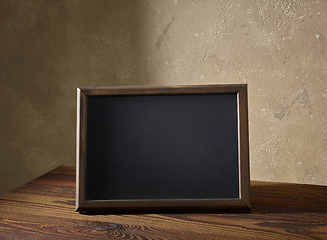 Image showing blackboard in a wooden frame on a table
