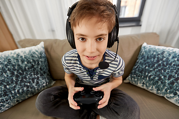 Image showing boy with gamepad playing video game at home