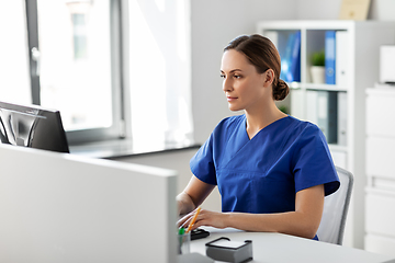 Image showing doctor or nurse with computer working at hospital