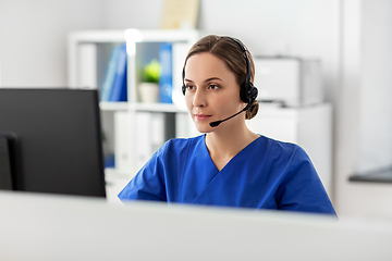 Image showing doctor with headset and computer at hospital