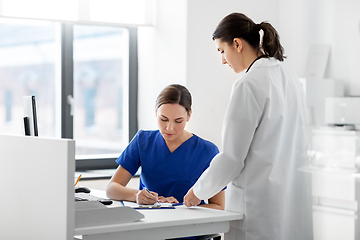 Image showing doctor and nurse with clipboard at hospital