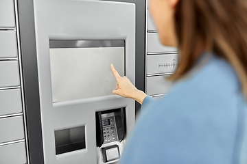 Image showing woman using automated parcel machine