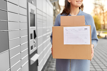 Image showing woman with boxes at automated parcel machine