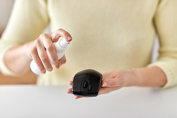 Image showing close up of woman cleaning computer mouse