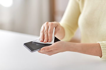 Image showing close up of hands cleaning smartphone with tissue