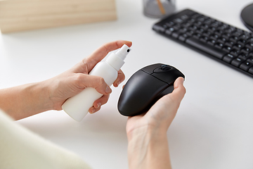 Image showing close up of woman cleaning computer mouse