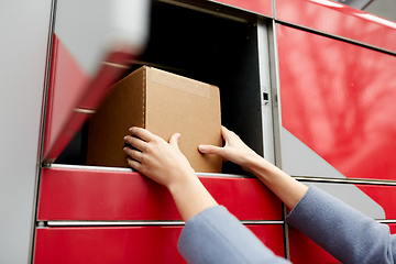 Image showing woman putting box to automated parcel machine