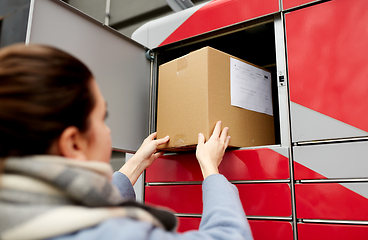 Image showing woman putting box to automated parcel machine