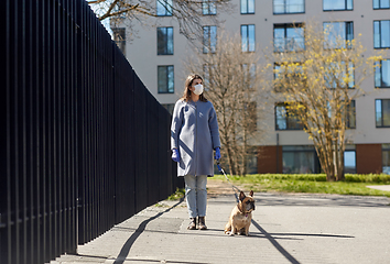 Image showing woman in mask and gloves with dog walking in city