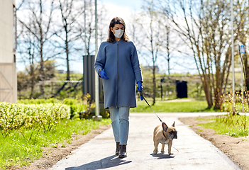 Image showing woman in mask and gloves with dog walking in city
