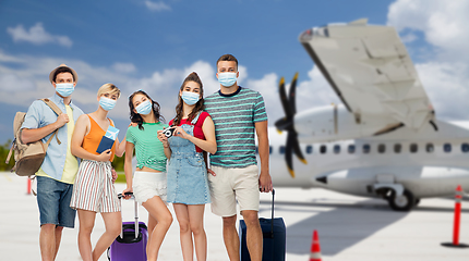 Image showing friends in masks with travel bags at airplane