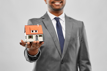 Image showing close up of indian man realtor with house model