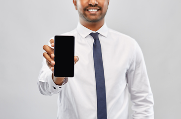 Image showing smiling indian businessman showing smartphone