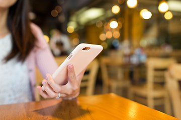 Image showing Woman sending sms on mobile phone