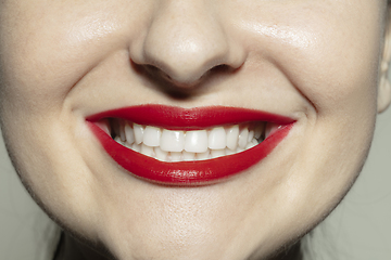 Image showing Close-up female mouth with bright red gloss lips make-up. Cosmetology, dentistry and beauty care, emotions