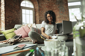 Image showing African-american woman, freelancer during the work in home office while quarantine