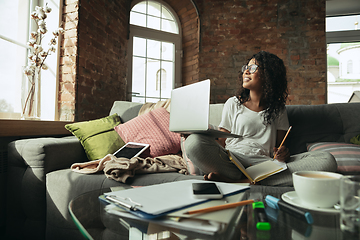 Image showing African-american woman, freelancer during the work in home office while quarantine