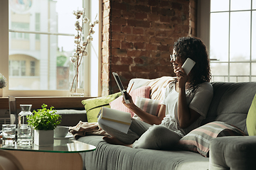 Image showing African-american woman, freelancer during the work in home office while quarantine