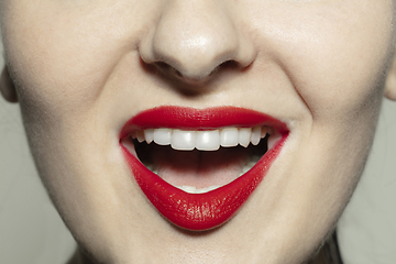 Image showing Close-up female mouth with bright red gloss lips make-up. Cosmetology, dentistry and beauty care, emotions