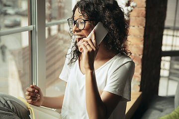 Image showing African-american woman, freelancer during the work in home office while quarantine