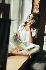 Image showing African-american woman, freelancer during the work in home office while quarantine