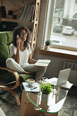 Image showing African-american woman, freelancer during the work in home office while quarantine