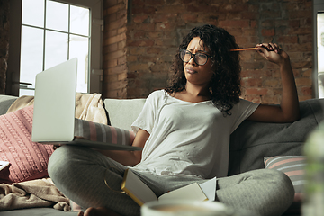 Image showing African-american woman, freelancer during the work in home office while quarantine