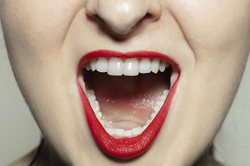 Image showing Close-up female mouth with bright red gloss lips make-up. Cosmetology, dentistry and beauty care, emotions