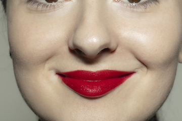 Image showing Close-up female mouth with bright red gloss lips make-up. Cosmetology, dentistry and beauty care, emotions