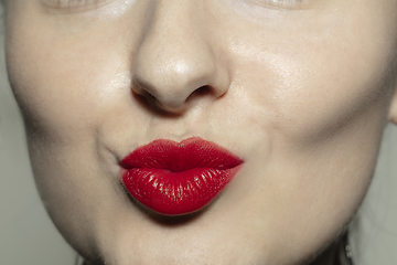 Image showing Close-up female mouth with bright red gloss lips make-up. Cosmetology, dentistry and beauty care, emotions