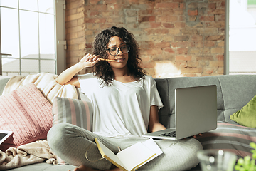 Image showing African-american woman, freelancer during the work in home office while quarantine