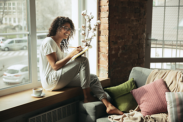 Image showing African-american woman, freelancer during the work in home office while quarantine