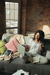 Image showing African-american woman, freelancer during the work in home office while quarantine