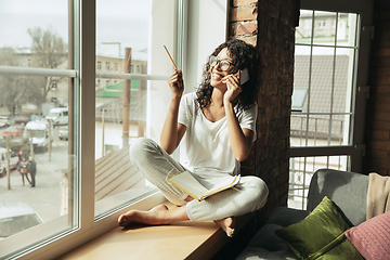 Image showing African-american woman, freelancer during the work in home office while quarantine